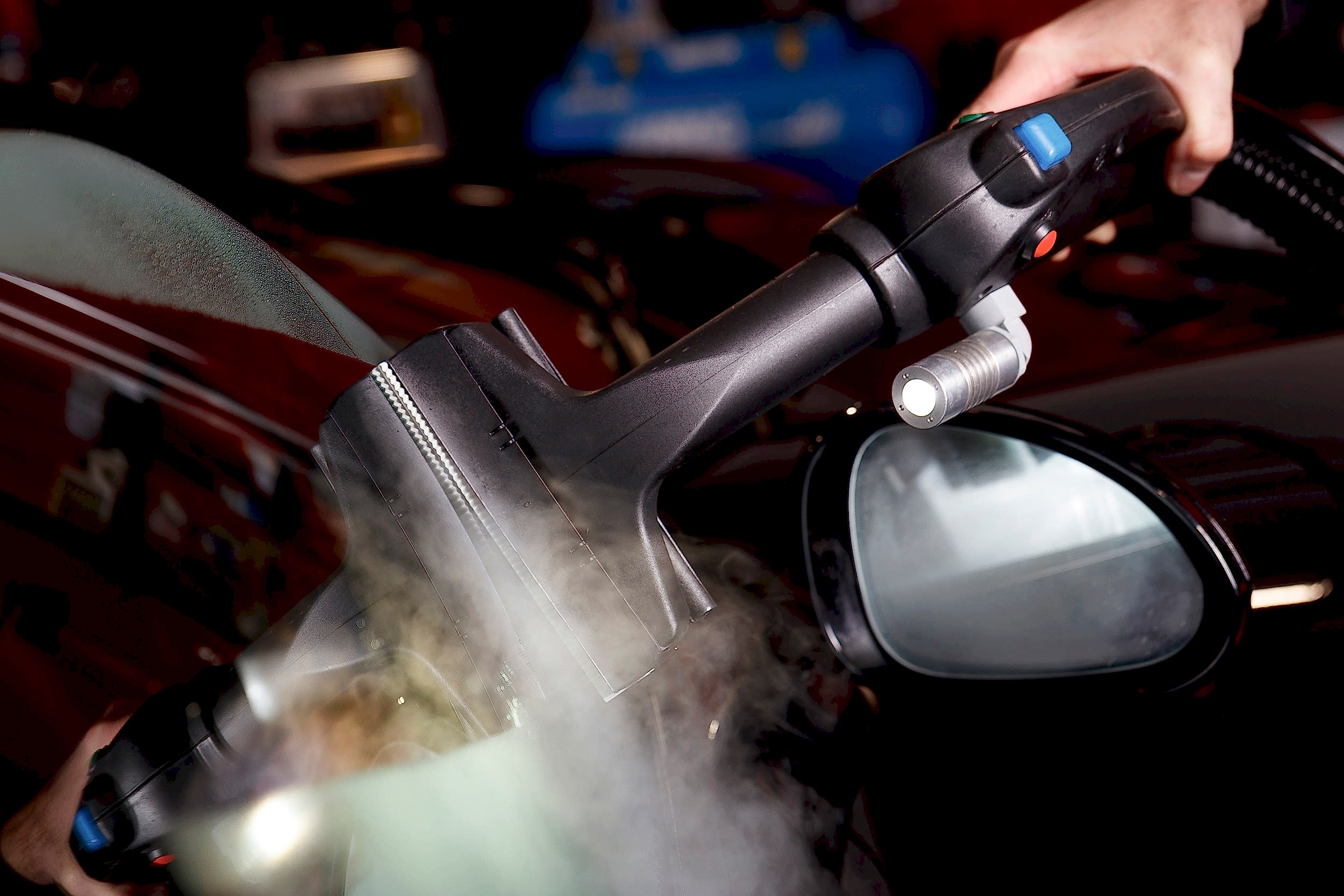 Steam car wash cleaning on windshield
