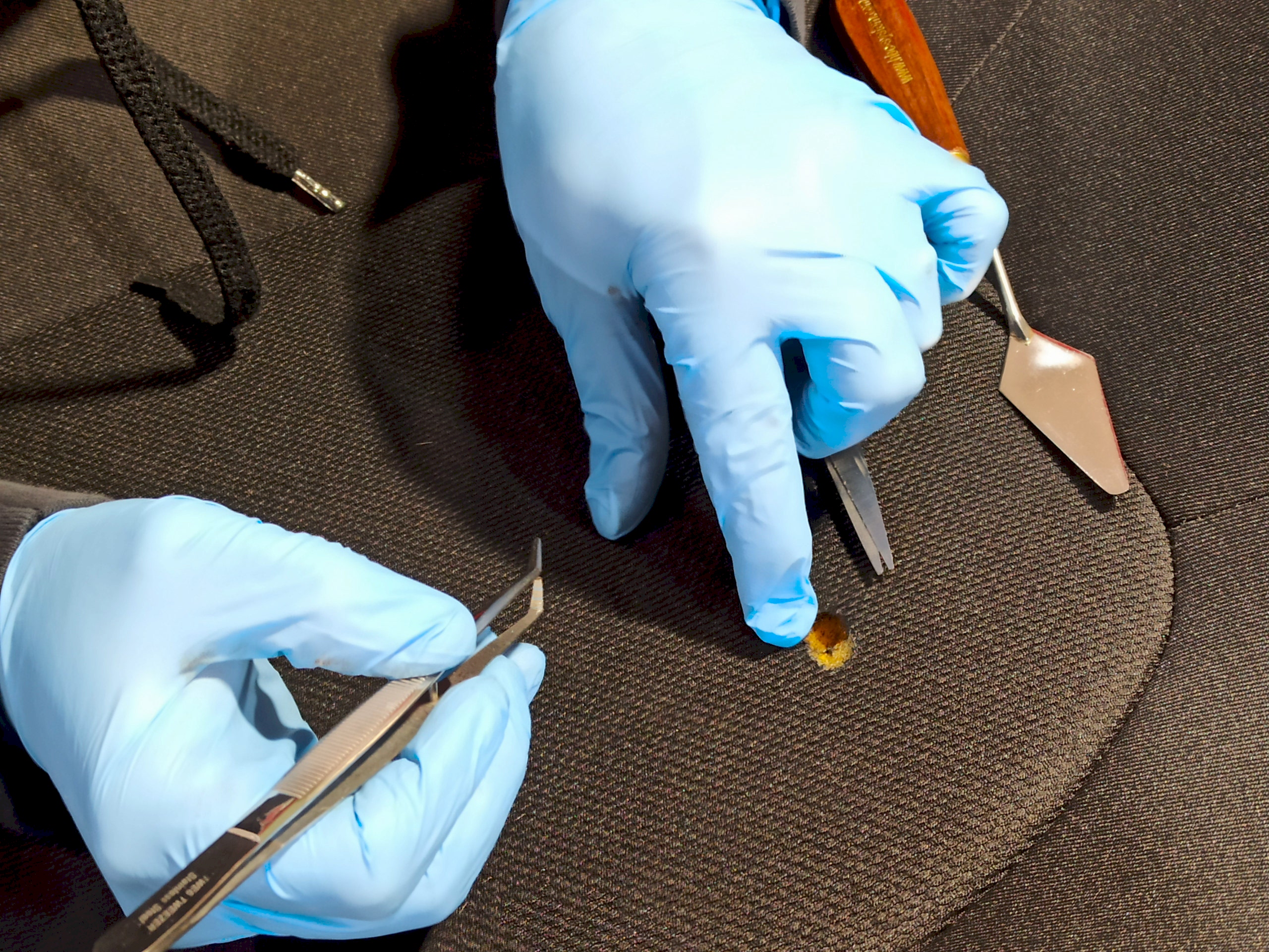 Car interior repairs of a cigarette burn on a seat
