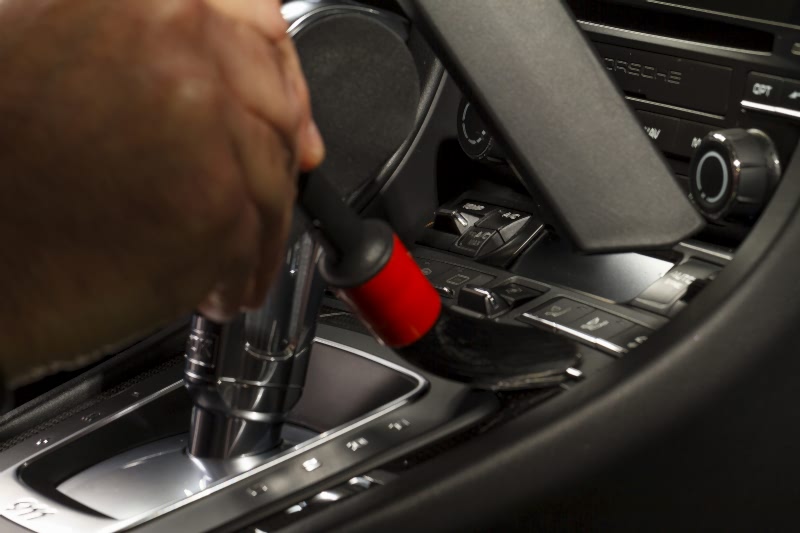 Vacuuming and dusting the car interiors 